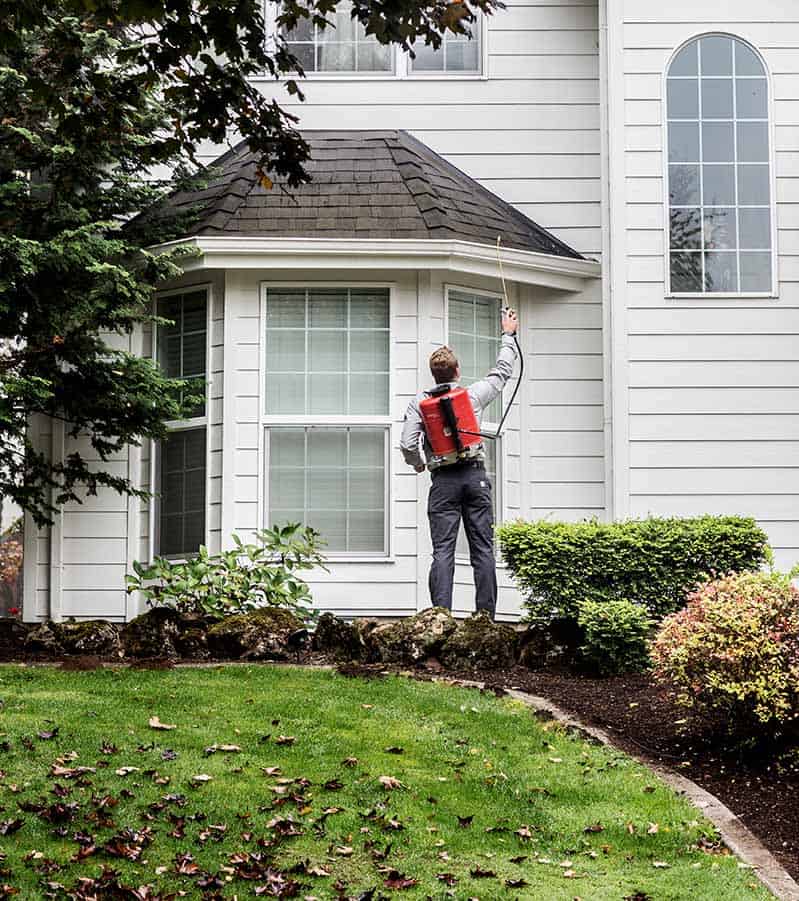 Aspen Pest Control Technician Treating a Vancouver WA Yard with Green Pest Control Product Aspen Pest Control Technician Treating a Vancouver WA Yard with Green Pest Control Product